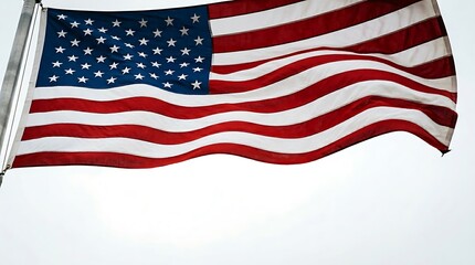 Obraz premium American flag waving in the wind with white stars on blue background and red and white stripes United States flag