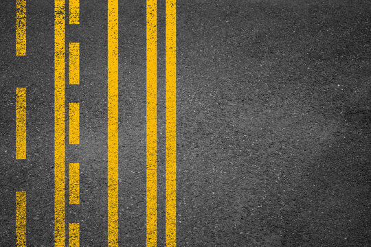 Yellow double line on tarmac road top view. Highway traffic mark vector illustration. Background with old paint texture on asphalt surface. Roadway seamless pattern. Straight urban driveway