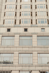 Fototapeta premium Views of a modern building with many windows in an urban area during daylight hours
