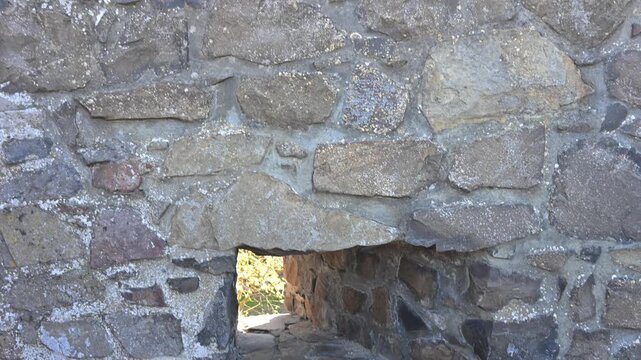 Close-up of an embrasure in a medieval stone wall.