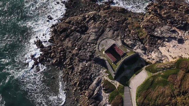 Aerial view of Forte da Lagarteira, a historic fort contrasting with the blue ocean and rocky coastline, Vila Praia de Ancora, Portugal.