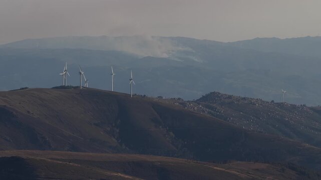 Aerial view of wind turbines contrasting against the mountainous terrain, creating a visual harmony between technology and nature, Amarante, Portugal.