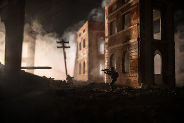 Obraz premium War Concept. Battle scene on war fog sky background, Fighting silhouettes Below Cloudy Skyline at night. City destroyed by war