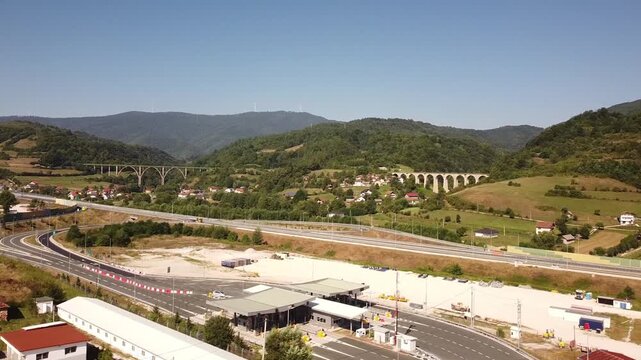 Tarčin, Bosnia and Herzegovina, located in central Bosnia, aerial drone view of highway, railway viaducts, rural landscape and mountains.