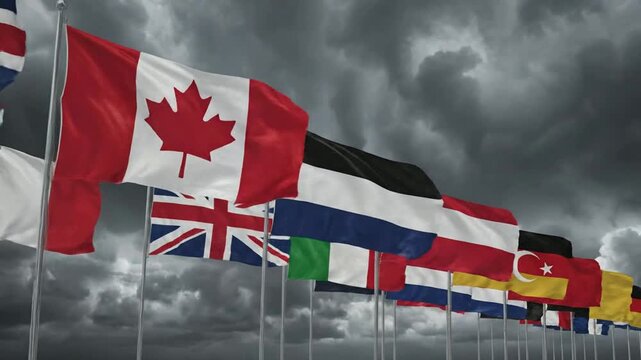 International flags waving against a dramatic stormy sky, global diplomacy and political tension concept