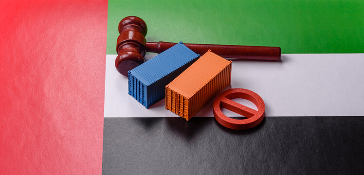 The cargo container ban on the UAE flag as a conceptual backdrop. The cargo container embargo