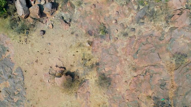 Top-Down Aerial View of Arid Rocky Terrain in Molepolole scattered boulders, dry scrub
