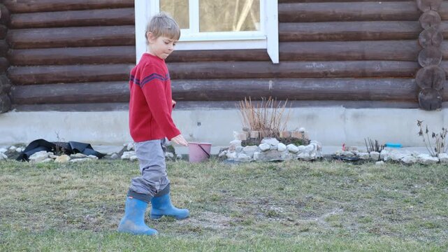 Little 6 years old kid boy practicing punches, karate, taekwondo movements at public park. Athlete child practicing martial arts outdoors. Training in autumn day. Nature background. Dynamic Kyungkido.