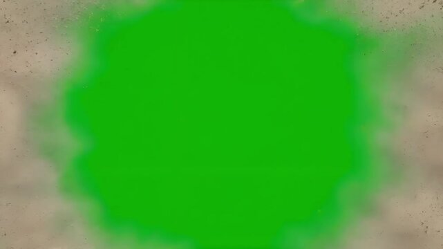 Debris explosion with flying brown rocks and dust over green screen chroma key