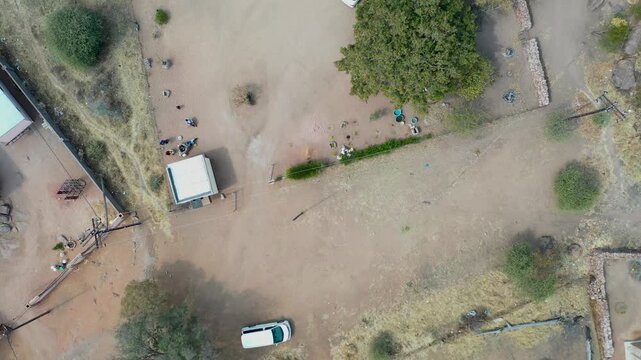 Top-Down Aerial View of a Residential Village Yard in Botswana shade tree, small outbuildings
