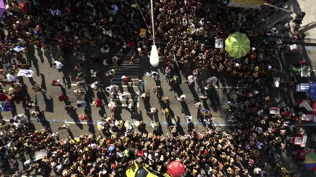 Aerial View, drone footage Top Down view of street of Rio de Janeiro in Brazilian Carnival block Parade crowded of people in sunny day