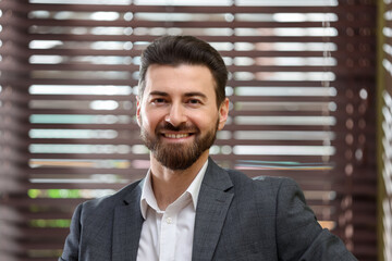 Naklejka premium Portrait of happy handsome businessman in office