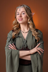 Naklejka premium Portrait of beautiful elf girl on brown gradient background