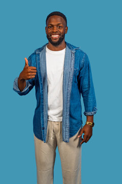 Confident man giving thumbs up gesture smiling brightly