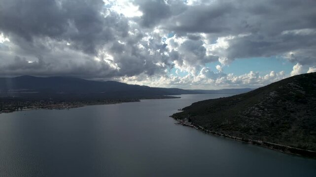4k view fying over the Gulf of Gera,  in Lesvos island, Greece, Europe, during a heavily overcast day with thich grey clouds