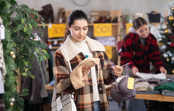 Seasonal trade sale, client at X mas holiday shopping time. Asian woman search and choose brassier, pick up some wardrobe items. Modern urban casual fashion