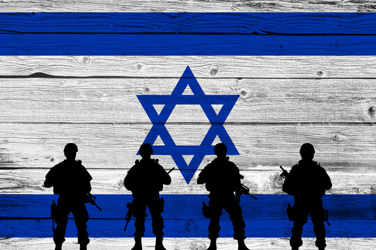 Flag of Israel painted on the brick wall with soldiers shadows. Gaza and Israel conflict. Terrorist organizations hezbollah and hamas. Israel Defense Forces or IDF