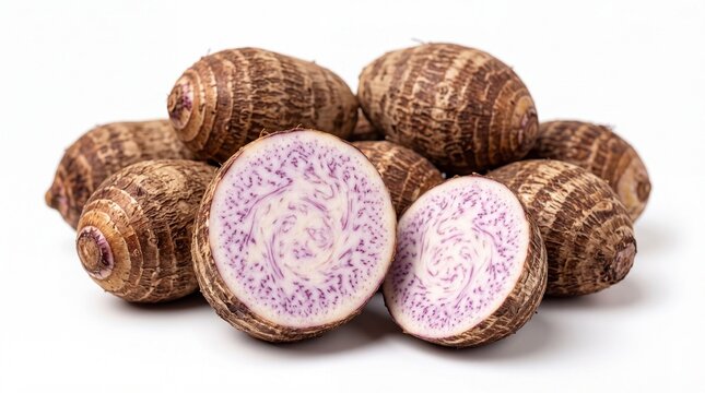 Collection of Raw Taro Corms on White Background with One Halved Taro