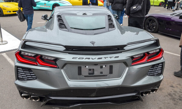 Sharp grey Chevrolet Corvette C8 with an aggressive front splitter and carbon fiber accents. Modern masterpiece of American engineering and mid engine design