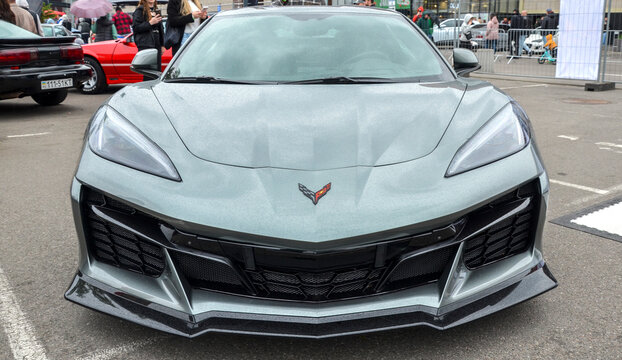 Sharp grey Chevrolet Corvette C8 with an aggressive front splitter and carbon fiber accents. Modern masterpiece of American engineering and mid engine design