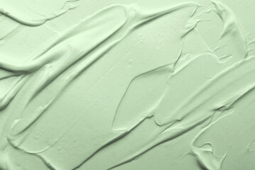 Green beauty skincare cream texture cosmetic product background. Strokes of cream, top view © Anna