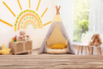 PLayroom and empty wooden table, selective focus. Space for design © New Africa