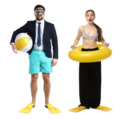 Office workers dreaming about vacation. Man and woman with inflatable ring, beach ball, diving mask and swim flippers on white background © New Africa