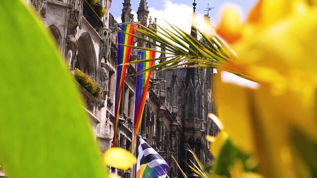 Regenbogenflaggen am Marienplatz in M&uuml;nchen eingerahmt von Palmen beim CSD