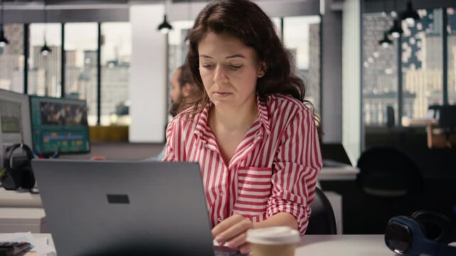 Woman staff working on laptop in smart office corporation at desk, providing business management for new strategy and project development. Worker ensuring productivity startup culture.