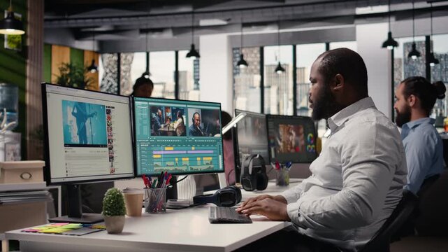 African american filmmaker editing video footage for content production, raw recorded clips on computer software. Videographer cutting frames and adding visual effects, film agency.