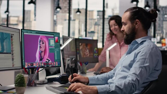 Male photographer working on image selection and editing in creative agency office, retouching photos with color grading on computer software. Commercial post production artistic tasks.