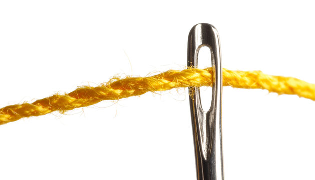 A vibrant yellow thread is carefully guided through the eye of a shiny silver sewing needle. Available in transparent background.