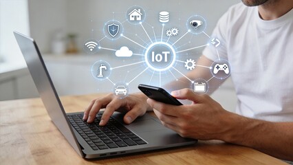 Fototapeta premium Man using laptop and smartphone with IoT concept smart home technology connected devices automation digital network internet of things wireless communication cloud computing data