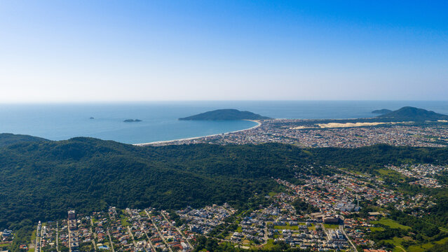 Sunny summer morning panorama of Praia dos Ingleses long sandy beach facing the open Atlantic in Florianopolis.
