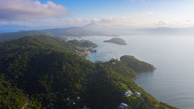 Aerial view of Caixa D Aco bay and Porto Belo coastline with boats and Atlantic forest mountains in Brazil.