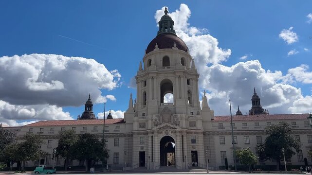 Pasadena City Hall with dramatic clouds and passing green truck in slow motion 4K