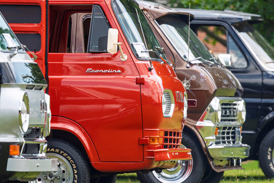 Row of 1962 vintage Ford Econoline vans at car show in Michigan