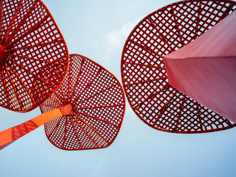 Abstract red sculpture, geometric metal, sky view - Modern art