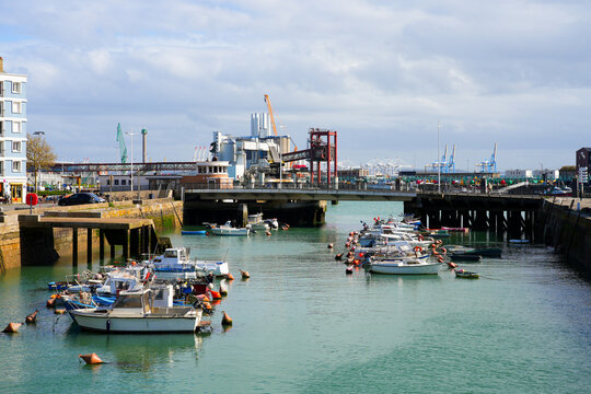 Scenic view of the Bassin du Roy harbor with fishing boats and industrial port infrastructure in the background, Le Havre, Normandy, France