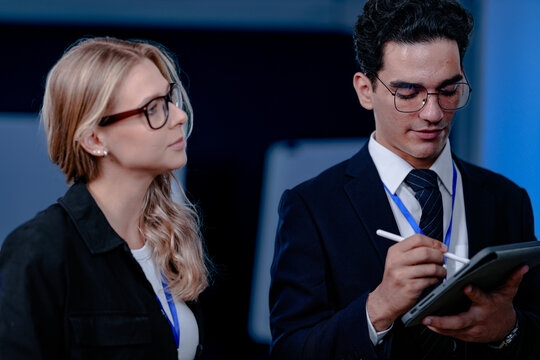 Unveiling the future. Smiling innovator presents a groundbreaking algorithm or quantum code on screen, explaining the next leap in AI or complex computation to his excited team.