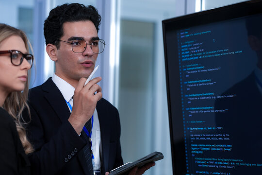 Positive code review vibes. Smiling tech lead guides colleague explaining successful script screen reflects collaborative synergy modern development hub winning team builds next big thing now.
