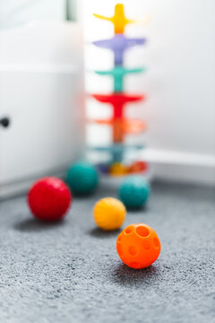 colorful toddler sensory balls and slide toys in child bedroom for early learning