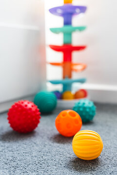 colorful toddler sensory balls and slide toys in child bedroom for early learning