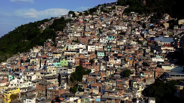 Drone Footage, Aerial View traveling in near to Favela Houses of Morro do Vidigal in Rio de Janeiro