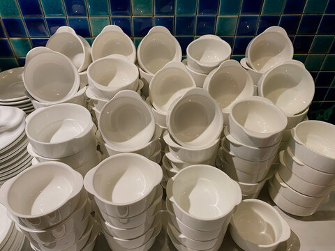These are white ceramic bowls with single tab handles, often referred to as "Grab-It" bowls.