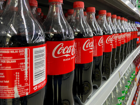 Batam, Indonesia - April 2026: Coca-Cola beverages arranged on supermarket shelves inside Hypermart store showing retail product display and beverage section.