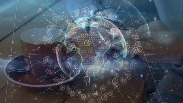 Man tapping smartphone on table, summoning rotating holographic globe over cup, visualizing tech