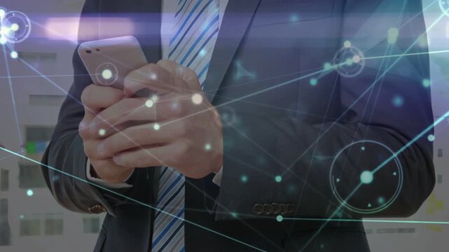 Businessman bringing phone forward as glowing overlay drifting, typing, showing workflow