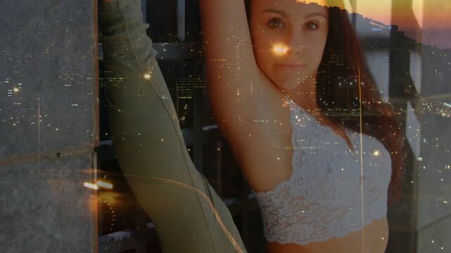 Woman pressing foot on column holding stretch rotating torso city light overlaying body for fitness
