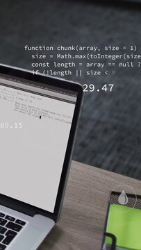 Vertical video: Laptop showing code, data causing UI icons and metrics updating for analytics